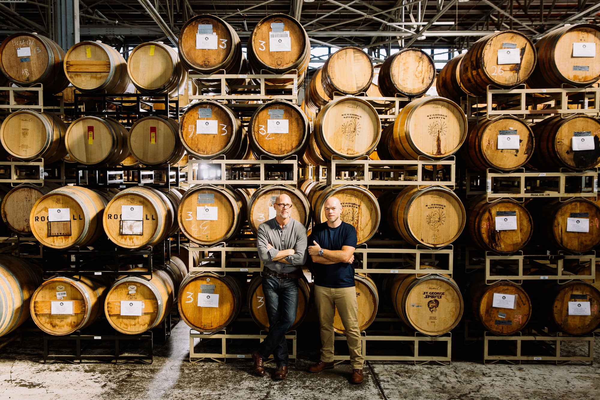 Lance Winter and David Smith standing in front of a rack of barrels