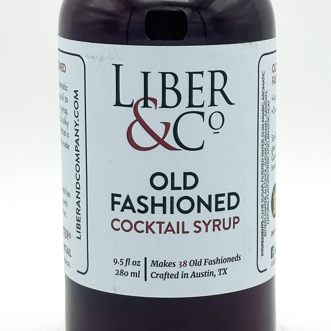Bottle of Liber & Co Old Fashioned Cocktail Syrup with label on a white background