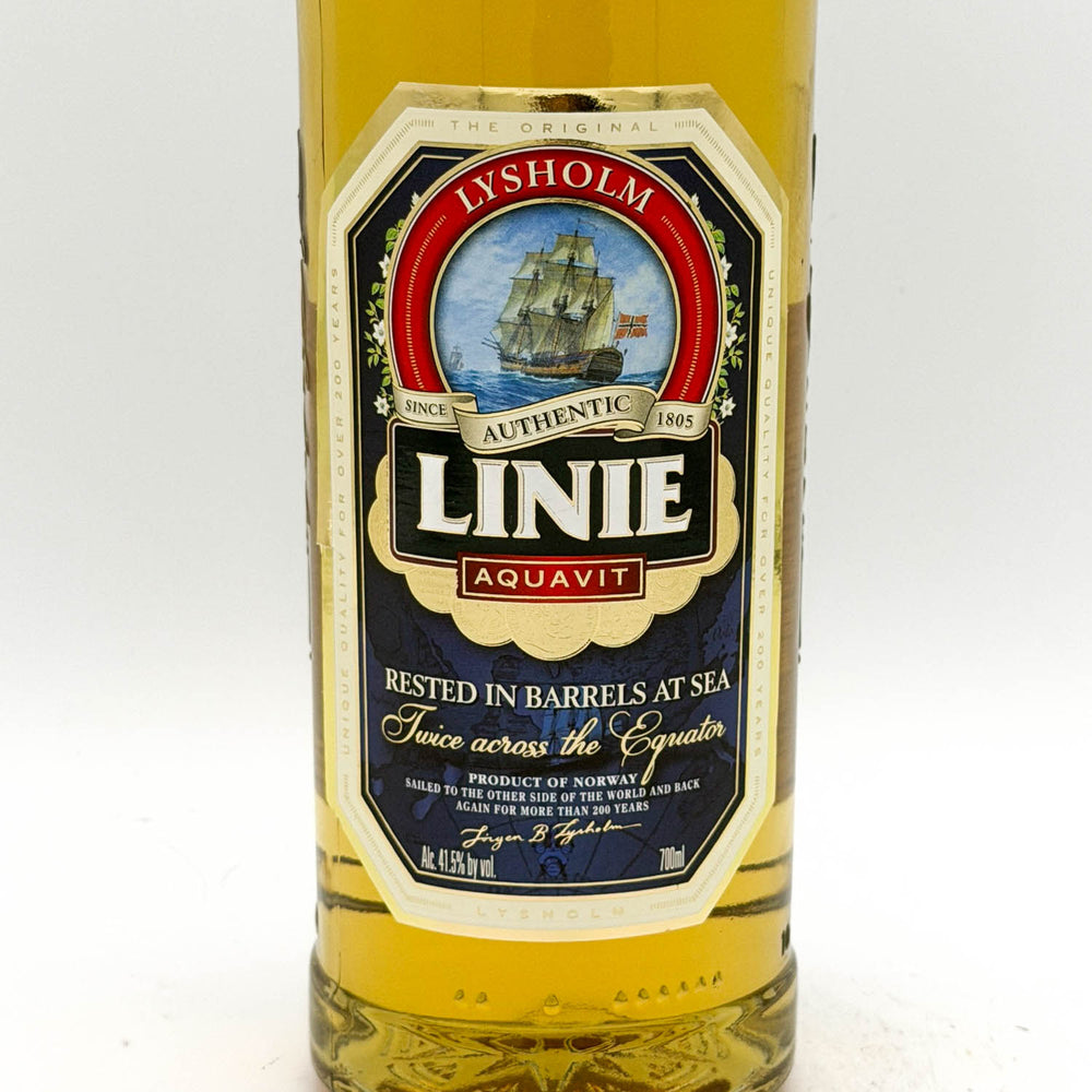 Bottle of Linie Aquavit with a prominent label on a white background