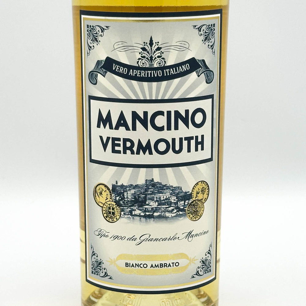 A bottle of Mancino Vermouth white vermouth wine with a cream and blue label, set against a plain white background.