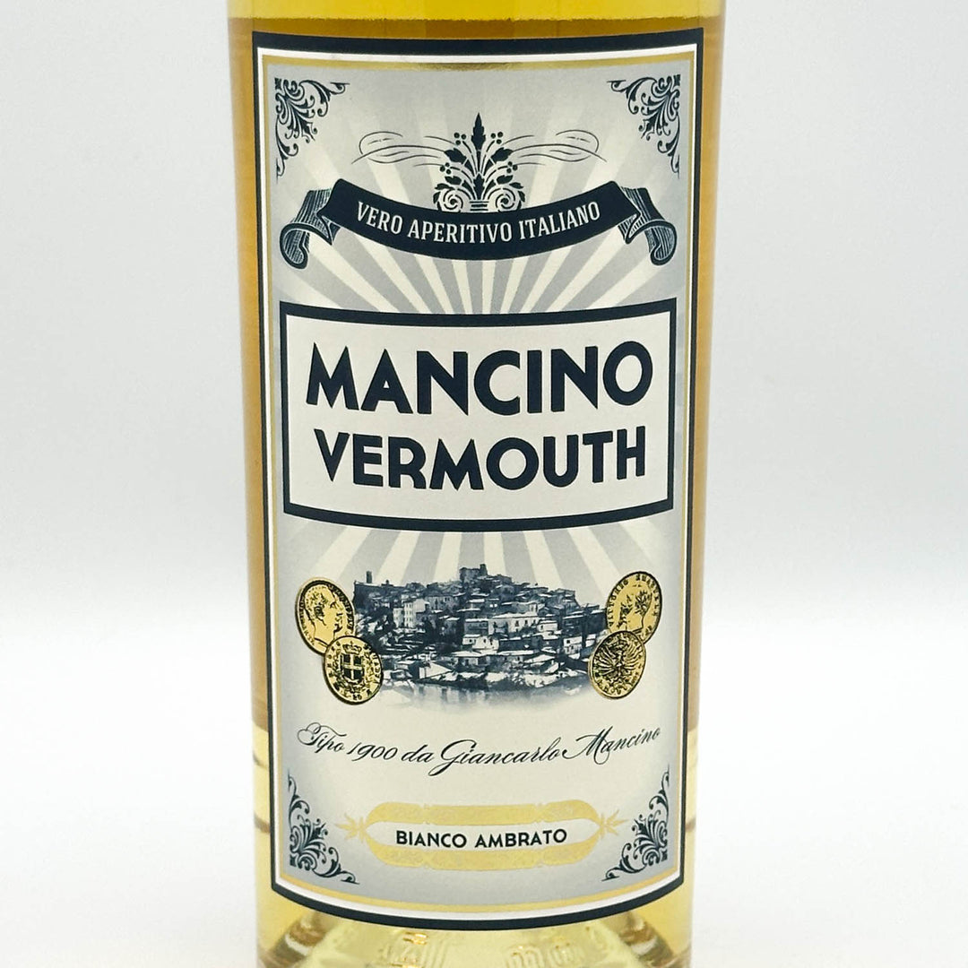 A bottle of Mancino Vermouth white vermouth wine with a cream and blue label, set against a plain white background.