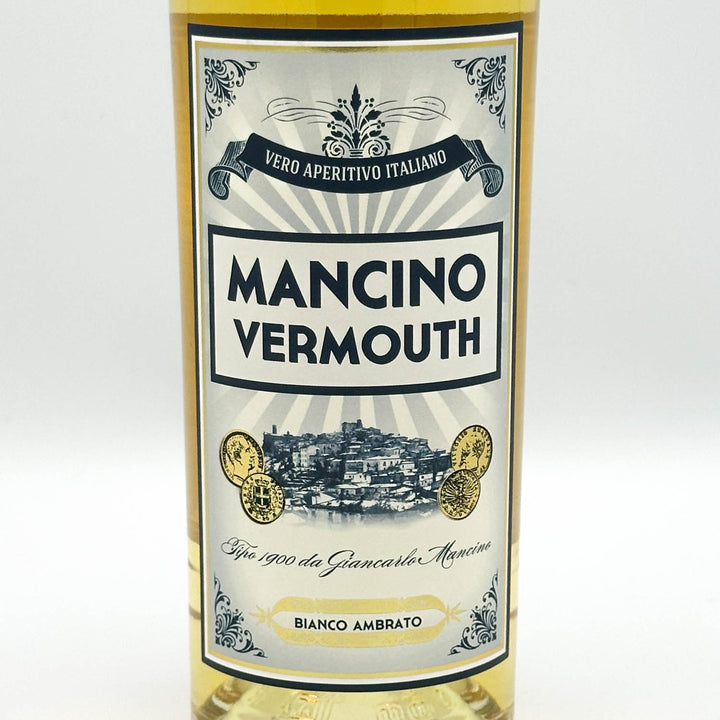 A bottle of Mancino Vermouth white vermouth wine with a cream and blue label, set against a plain white background.
