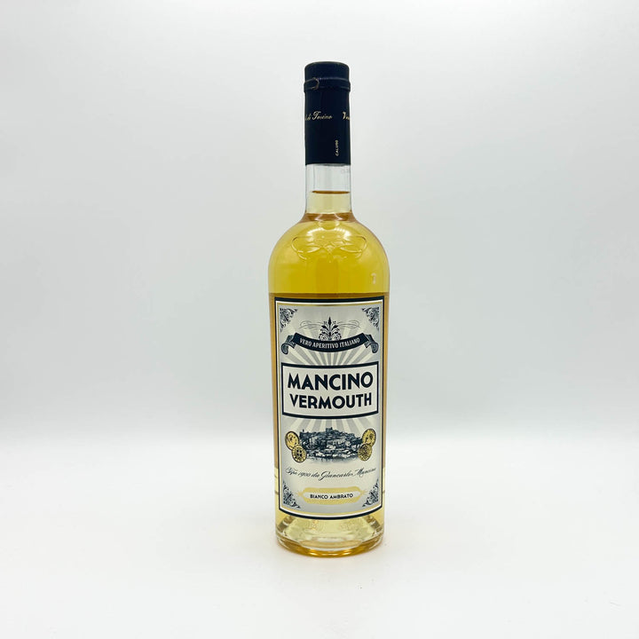 A bottle of Mancino Vermouth white vermouth wine with a cream and blue label, set against a plain white background.