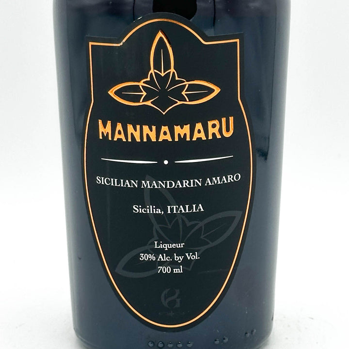 Bottle of Mannamaru Sicilian Mandarin Amaro with a black label on a white background