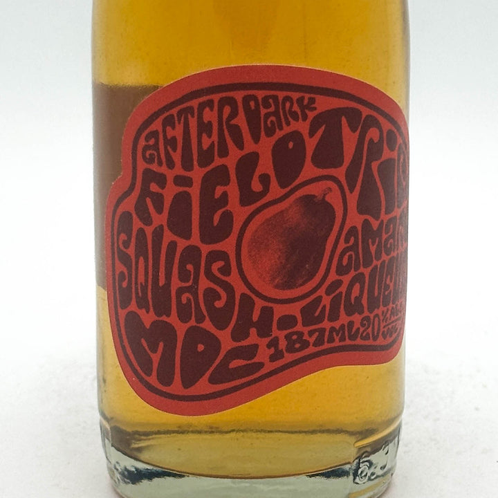Bottle of Day Trip Squash Maple Liqueur with a red label on a white background