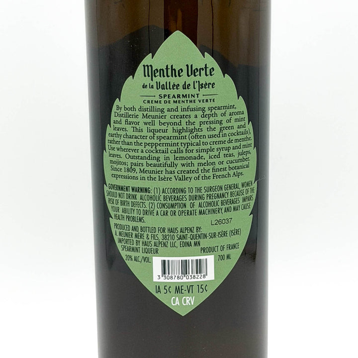 Bottle of Menthe Verte de la Vallee de l'Isere with green label on a white background
