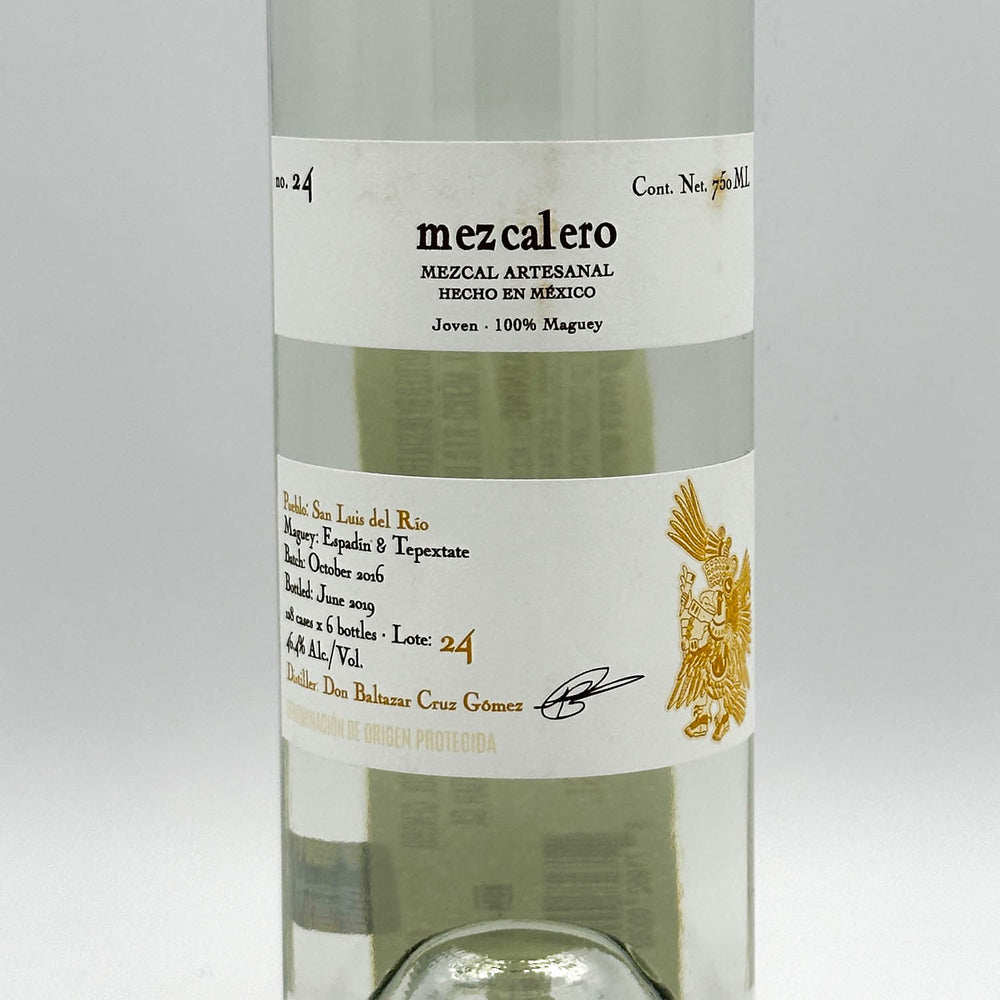 Bottle of Mezcalero mezcal with a white label on a light gray background