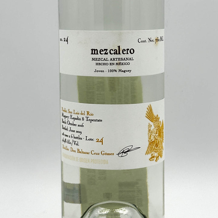 Bottle of Mezcalero mezcal with a white label on a light gray background