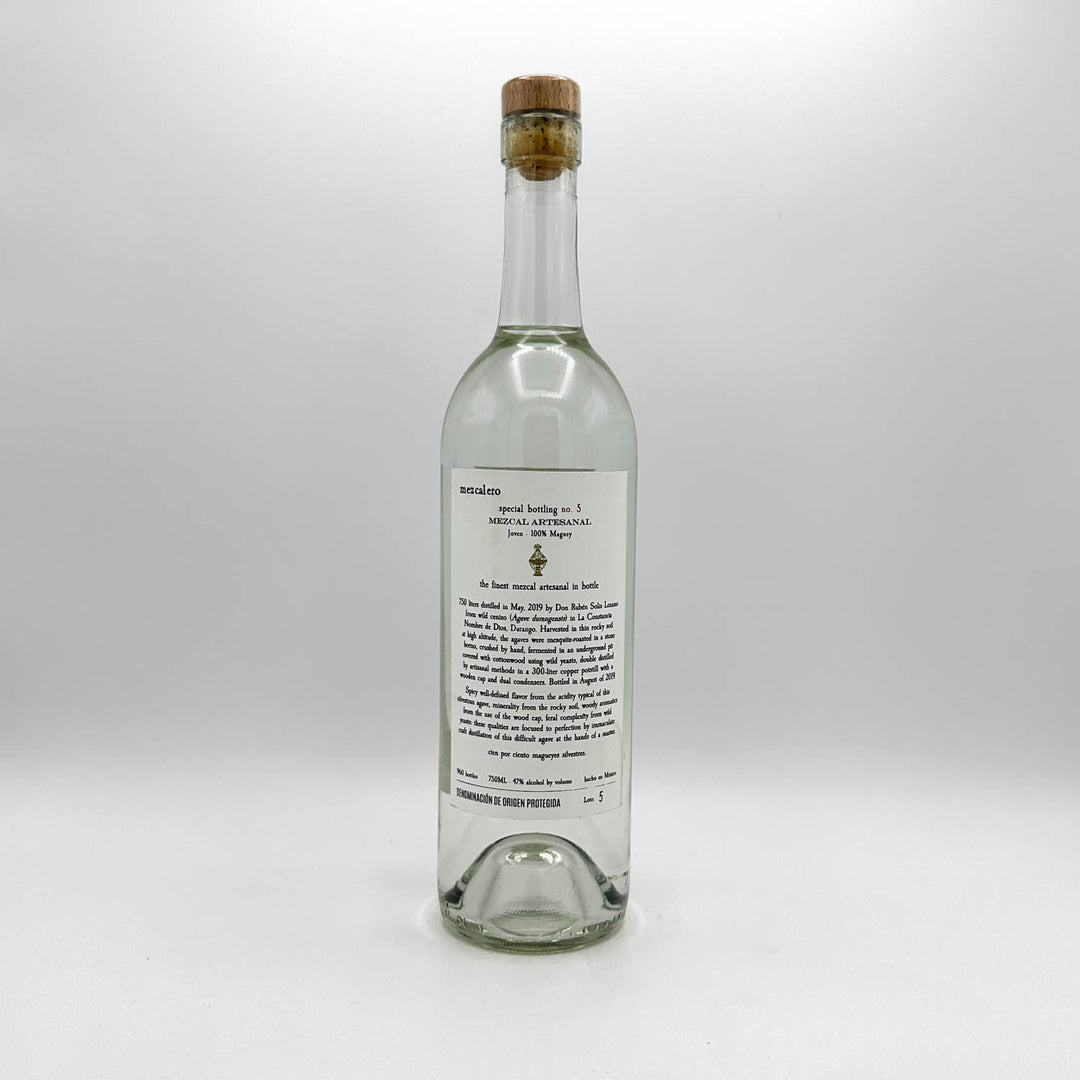 Clear glass bottle with cork stopper on a white background
