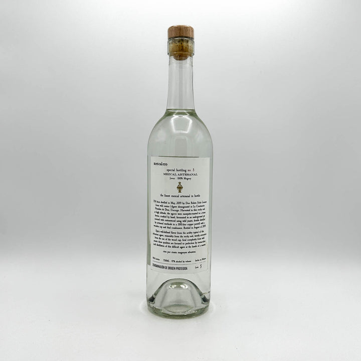 Clear glass bottle with cork stopper on a white background