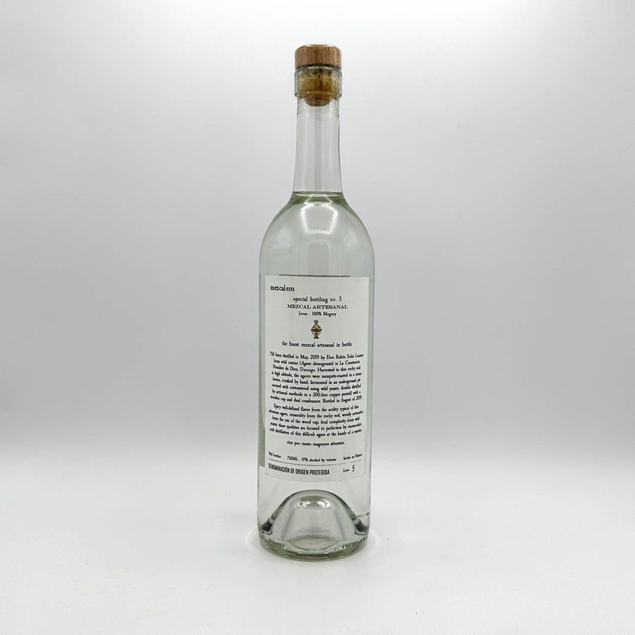 Clear glass bottle with cork stopper on a white background