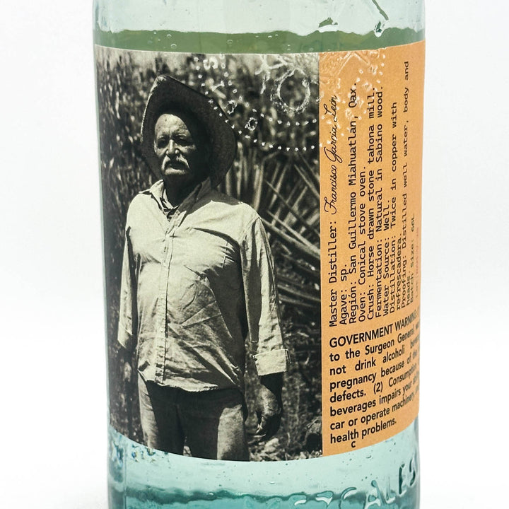 Bottle label with a black and white photo of a man and text on a white background