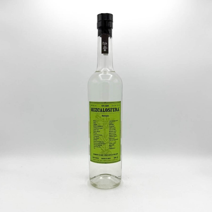 Bottle of Mezcal Oaxaca with a green label on a white background