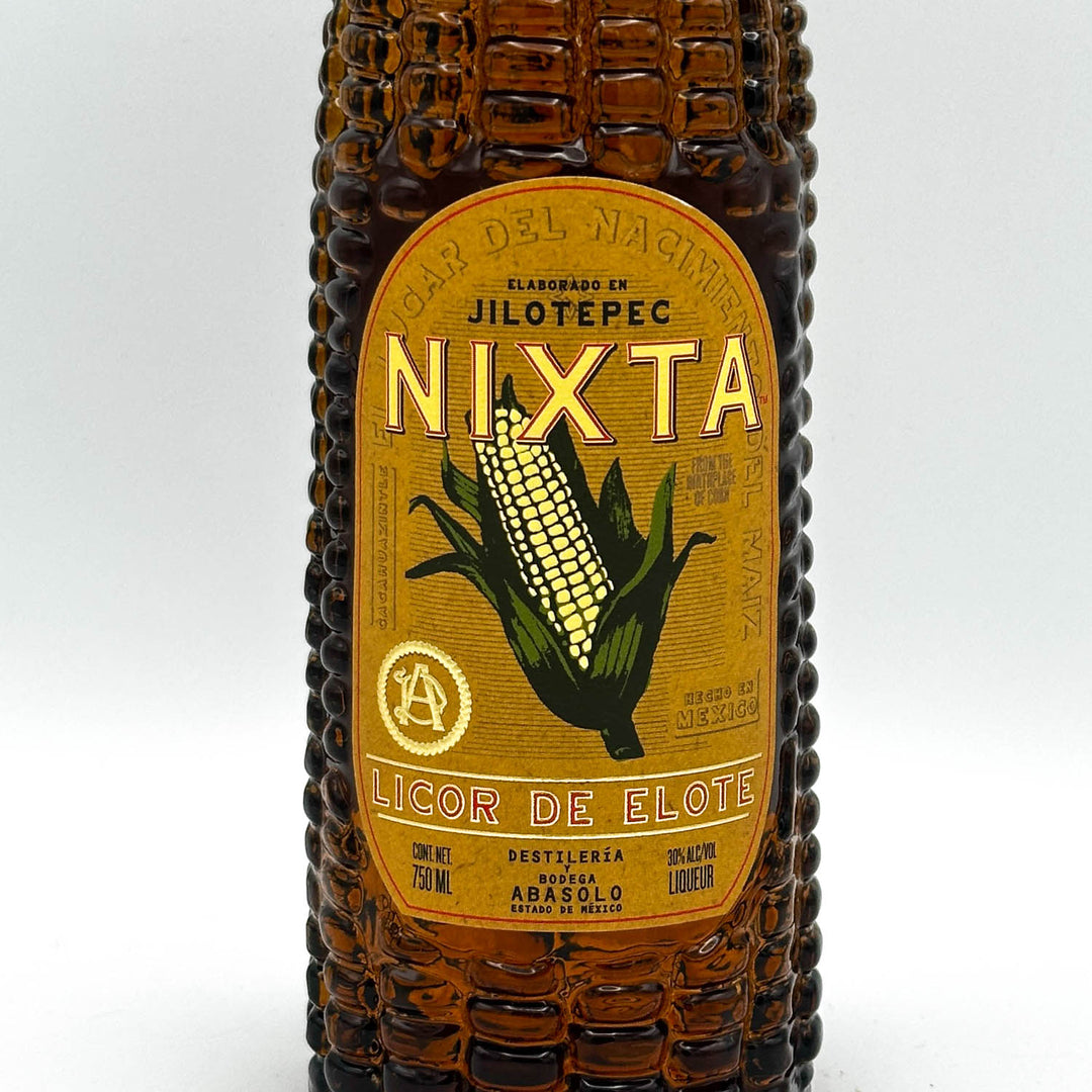 Bottle shaped like an ear of corn with Nixta Licor de Elote label on a white background