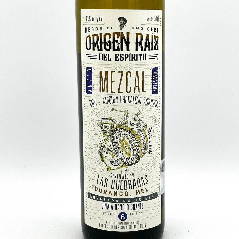 Mezcal bottle with a detailed label on a white background