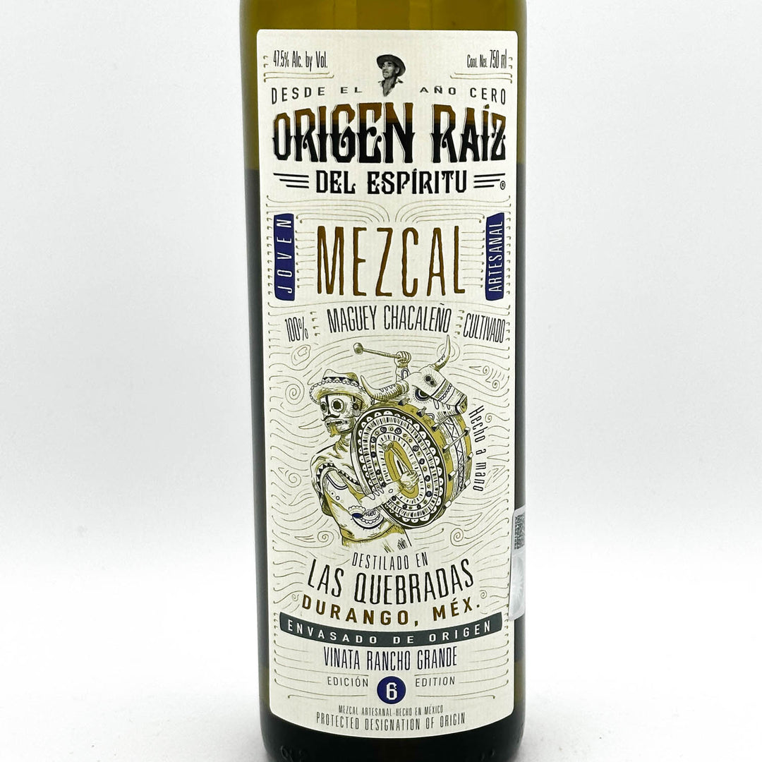 Mezcal bottle with a detailed label on a white background