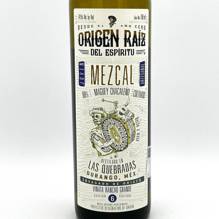 Mezcal bottle with a detailed label on a white background