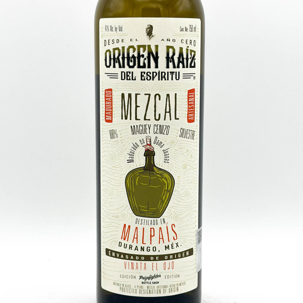 Mezcal bottle with a detailed label on a white background