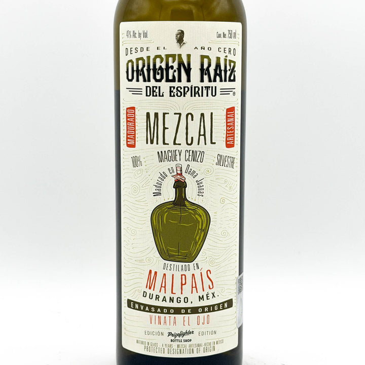 Mezcal bottle with a detailed label on a white background