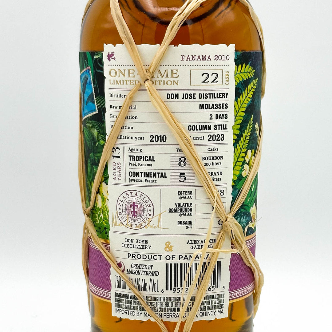 Bottle of Don Jose Distillery Panama 2010 rum with decorative string on a white background