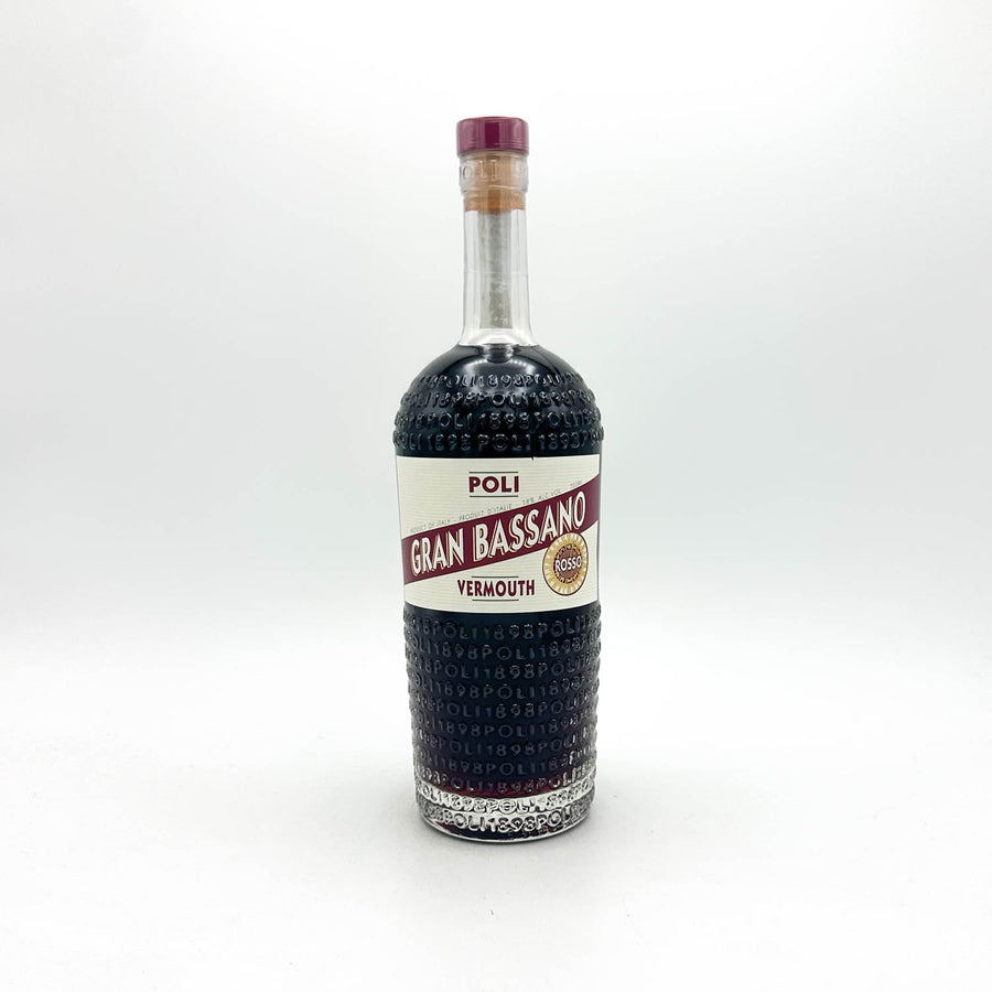 A bottle of Poli Gran Bassano Vermouth non-alcoholic, featuring a textured dark glass body, a white and red label, and a purple cork stopper, set against a plain white background.