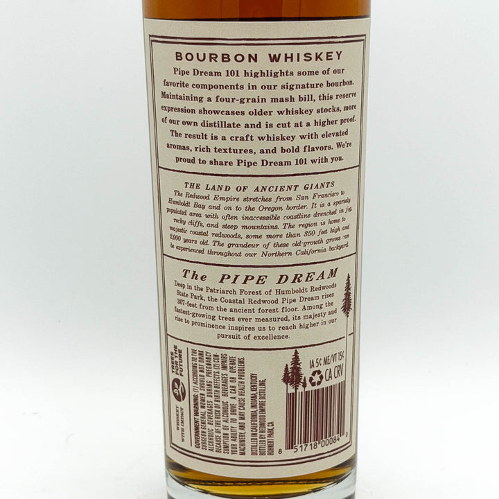 The back of a bottle of Pipe Dream 101 Bourbon Whiskey, showing the label text and barcode against a white background.