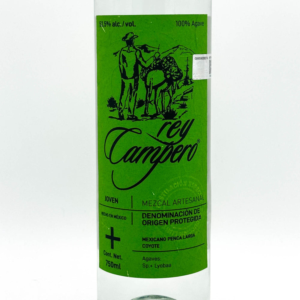 A 750ml bottle of Rey Campero Agaves Mezcal Artesanal, featuring a vibrant green label with black text and an illustration of a man and a llama.