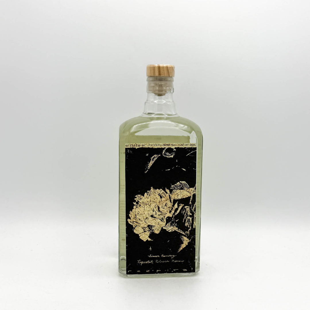Clear glass bottle with a cork stopper on a white background