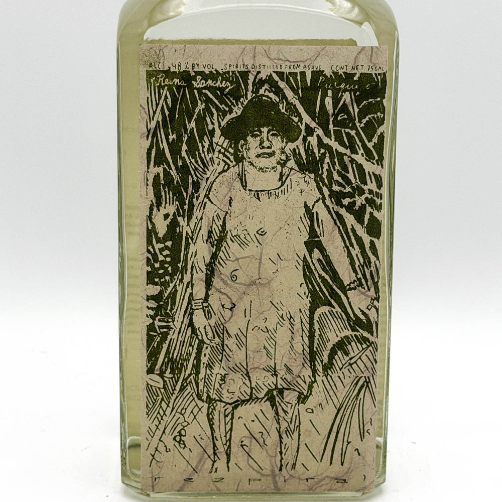 Glass bottle with a printed label featuring a person in a hat and coat.