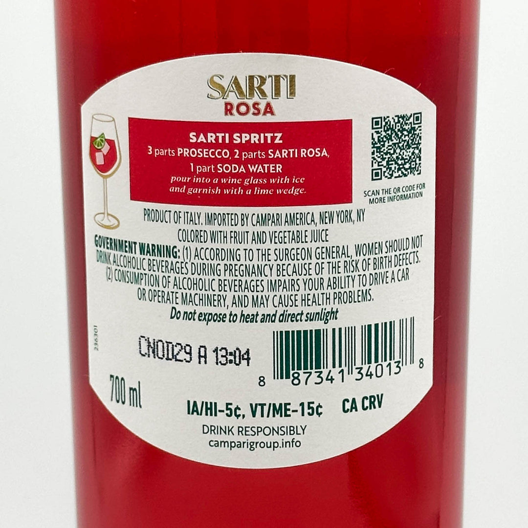 Close-up of a red cylindrical bottle label for Sarti Rosa Sarti Spritz, showing product details, ingredients, barcode, and QR code on a white background.
