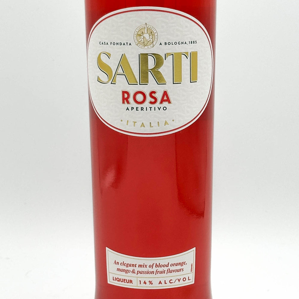 A close-up of a red bottle of Sarti Rosa Aperitivo liqueur, featuring a white oval label with gold and red lettering on a clean white background.