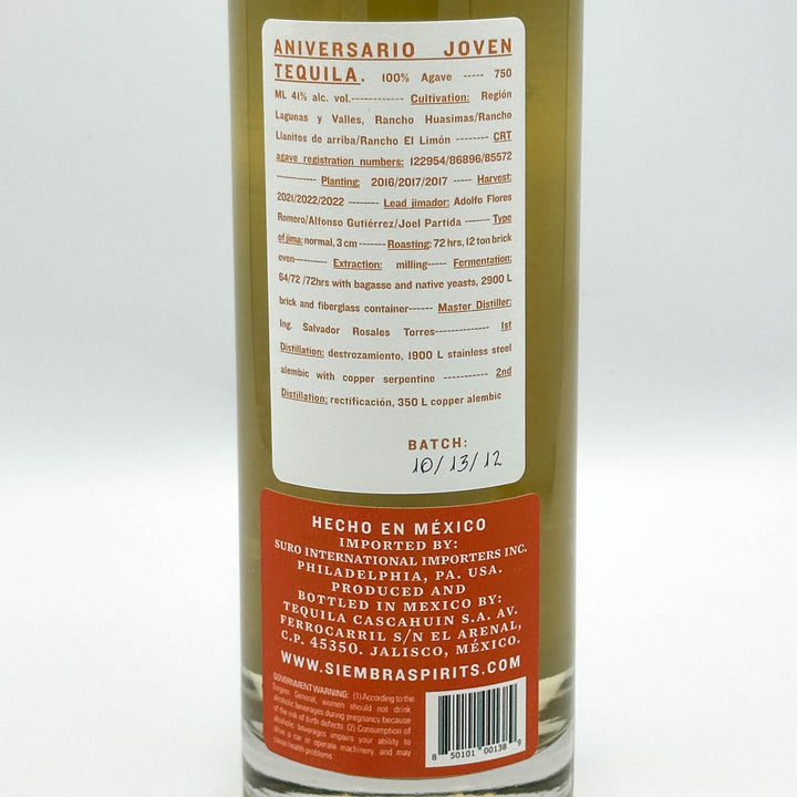 Back label of a tequila bottle with a cream top label and a red bottom label, showing product details and branding for Siemerbraspirits.