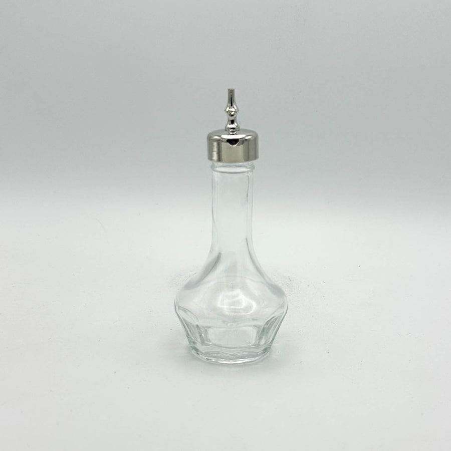 Clear glass bottle with a silver cap on a white background