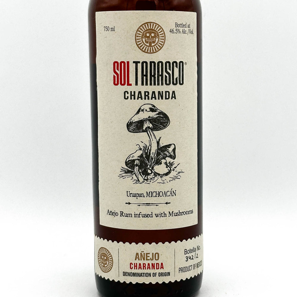 Bottle of Sol Tarasco Charanda rum with a mushroom illustration on a white background