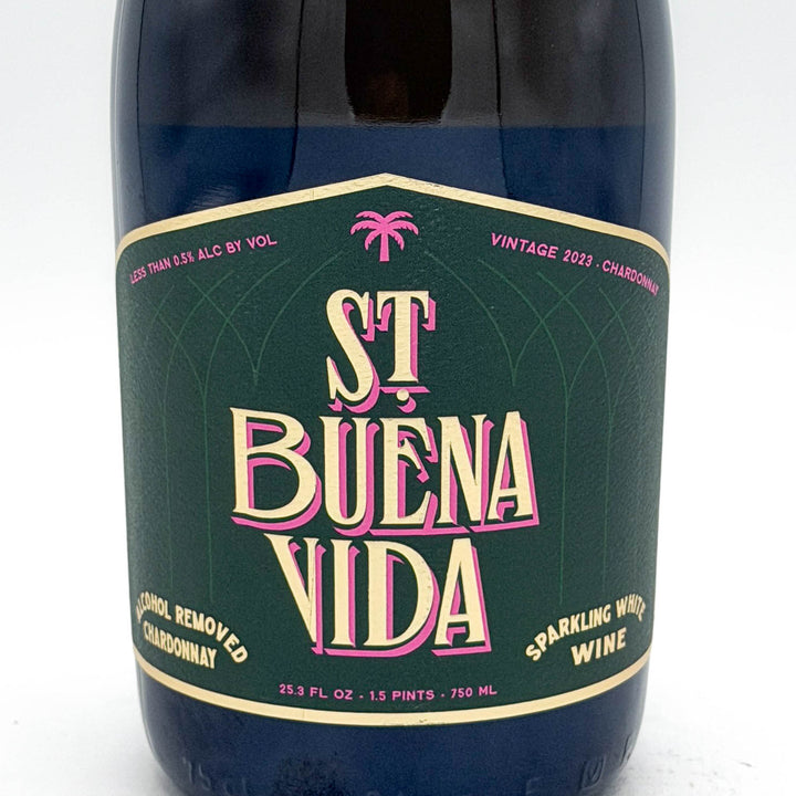 Bottle of St. Buena Vida sparkling wine with a green label on a white background