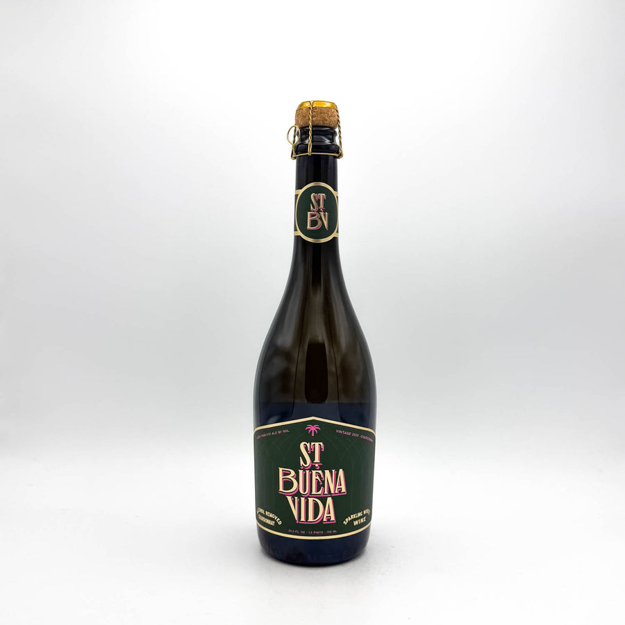 Bottle of St Buena Vida beer with a green label on a white background