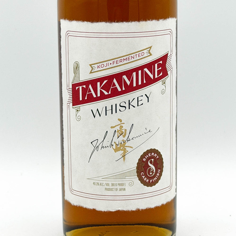 Bottle of Takamine Whiskey with a white label on a white background
