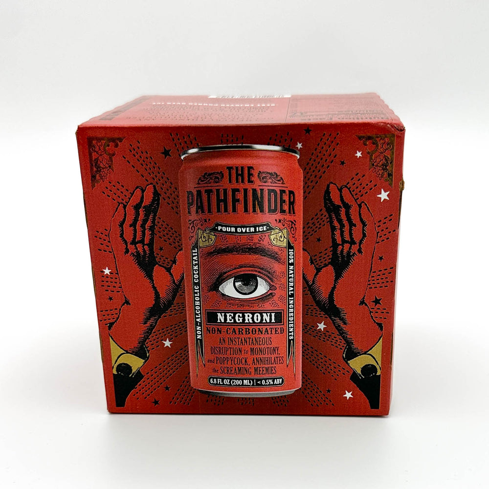 A red beverage can from The Pathfinder brand displayed in front of its matching red packaging box, both featuring black illustrated hands, stars, and an eye graphic. The can is labeled 'NEGRONI' and is photographed on a clean white background.