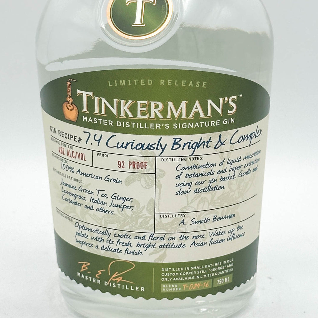 A bottle of Tinkerman's Signature Gin with a large white and dark green label, photographed against a plain white background.