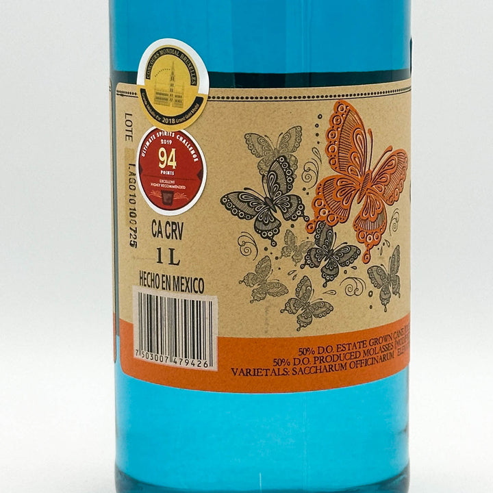 Bottle with decorative label featuring butterflies on a white background
