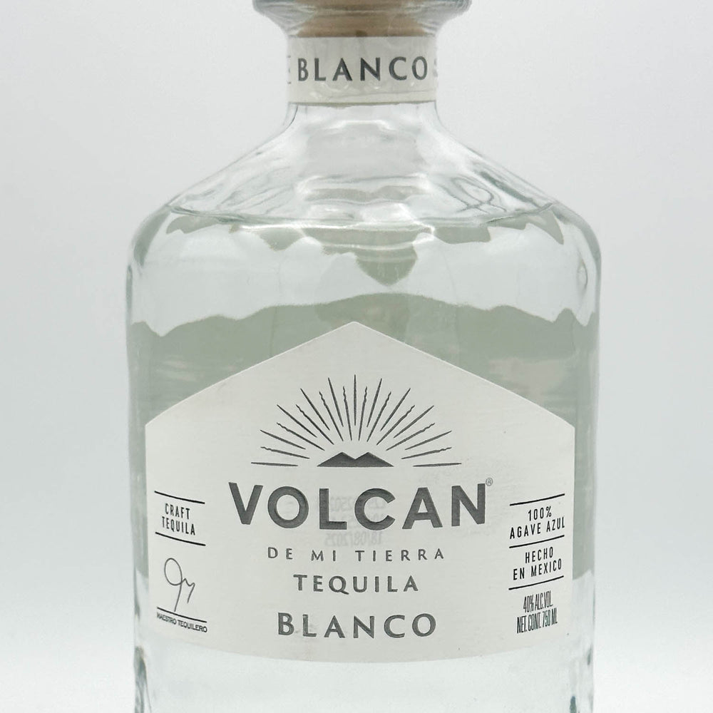 Volcan Blanco tequila bottle on a light gray background