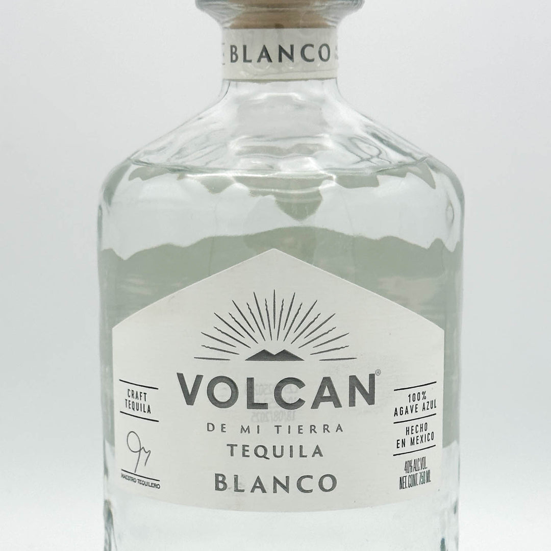 Volcan Blanco tequila bottle on a light gray background