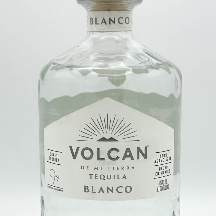 Volcan Blanco tequila bottle on a light gray background