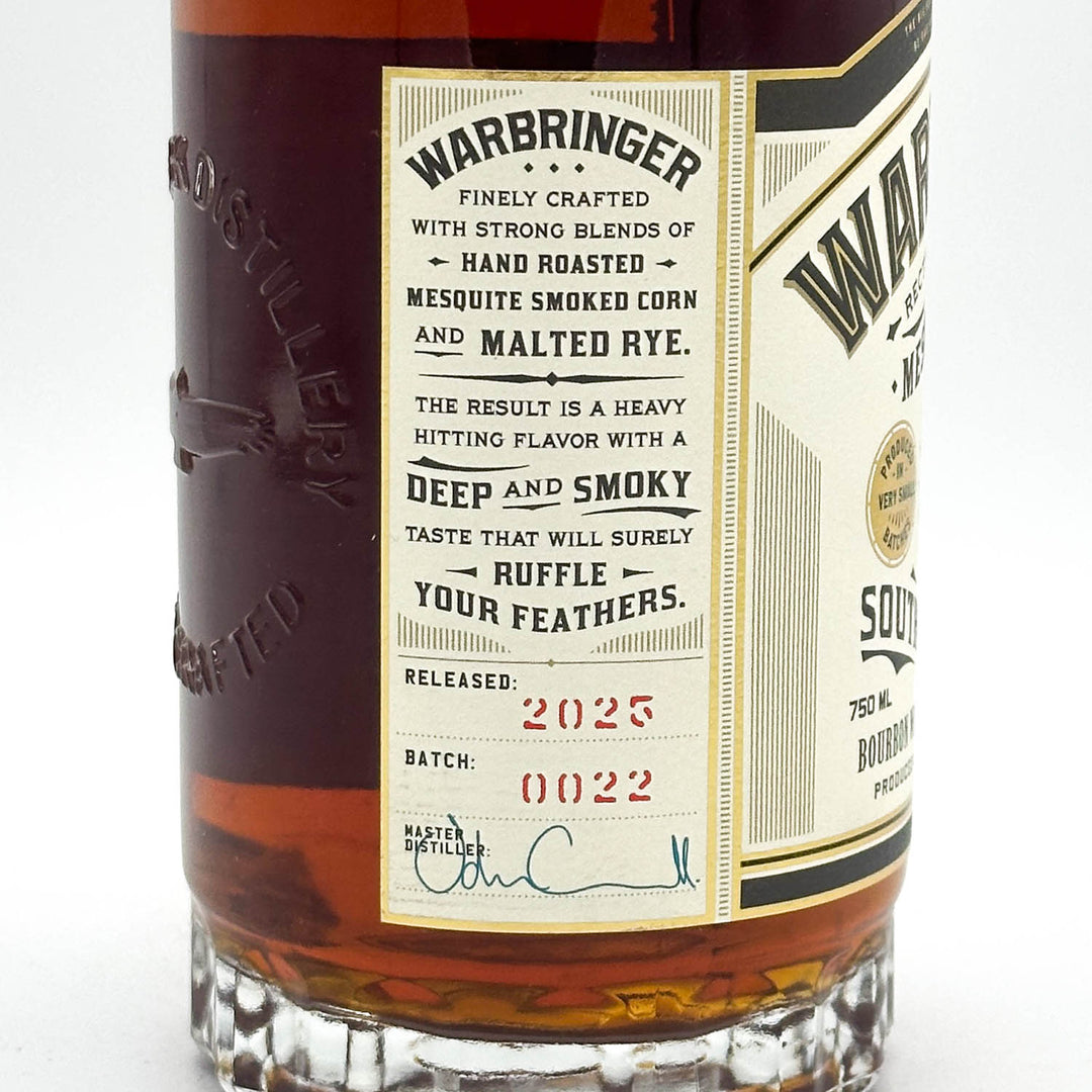 Warbringer whiskey bottle with detailed label on a white background