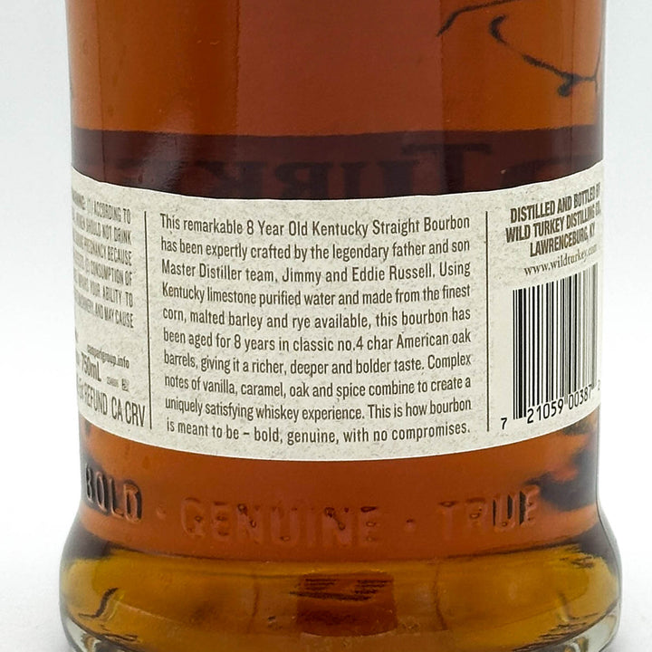 Back label of a Wild Turkey bourbon bottle with text and branding.