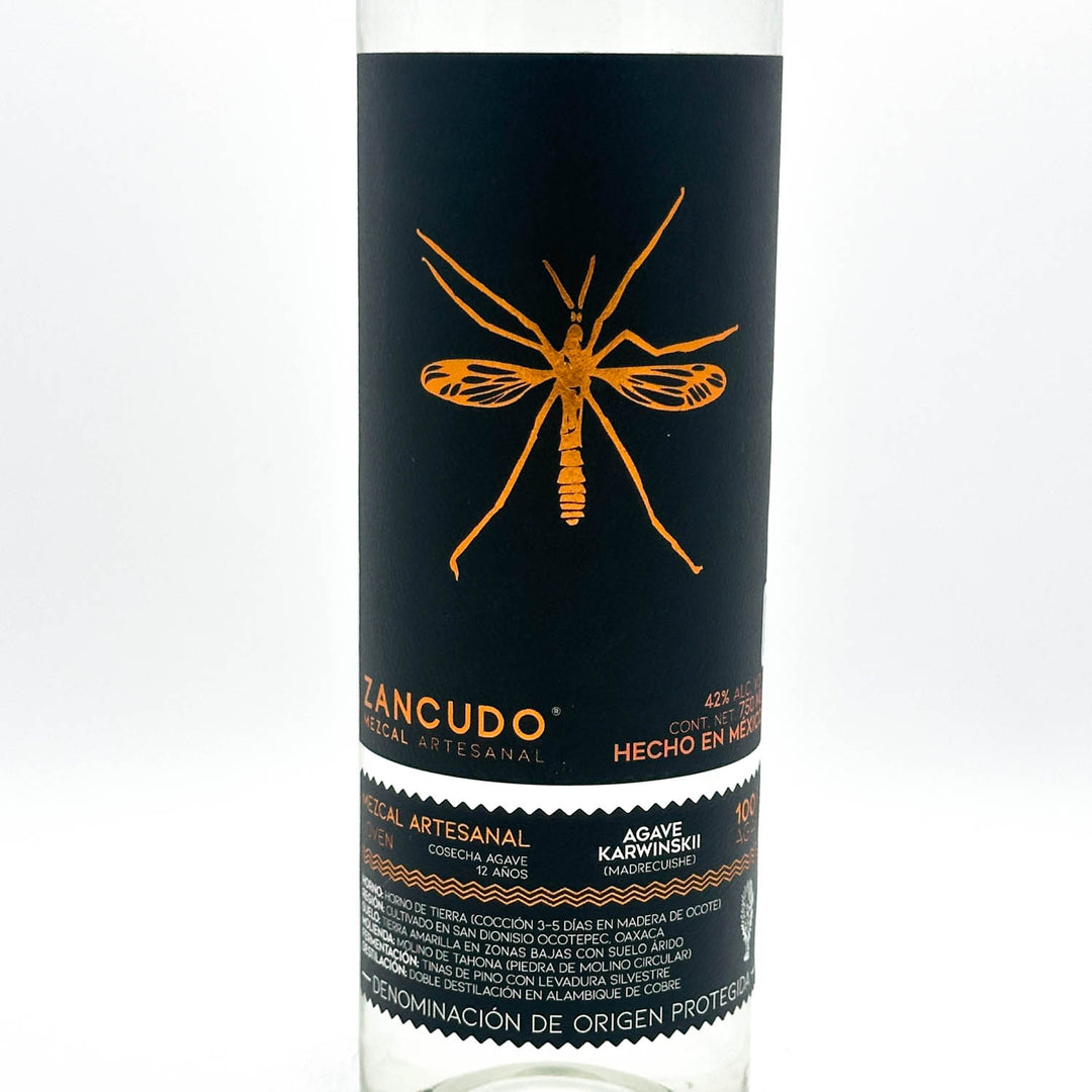 Bottle of Zancudo tequila with a black label featuring an orange mosquito illustration on a white background.